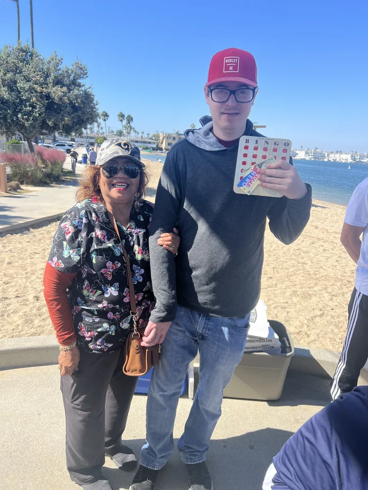 Caregiver and resident enjoying a community outing at the beach